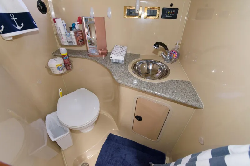 Slide: The Image of 2002 Cruisers Yachts 3275 Express bathroom with sink, toilet, and storage. - 14
