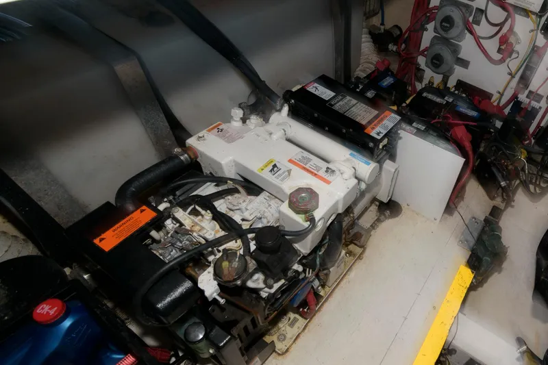 Slide: The Image of Engine compartment of a 2002 Cruisers Yachts 3275 Express with batteries and wiring. - 17