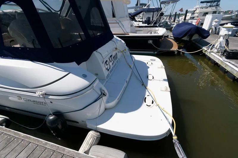 Slide: The Image of 2002 Cruisers Yachts 3275 Express docked at a marina. - 2
