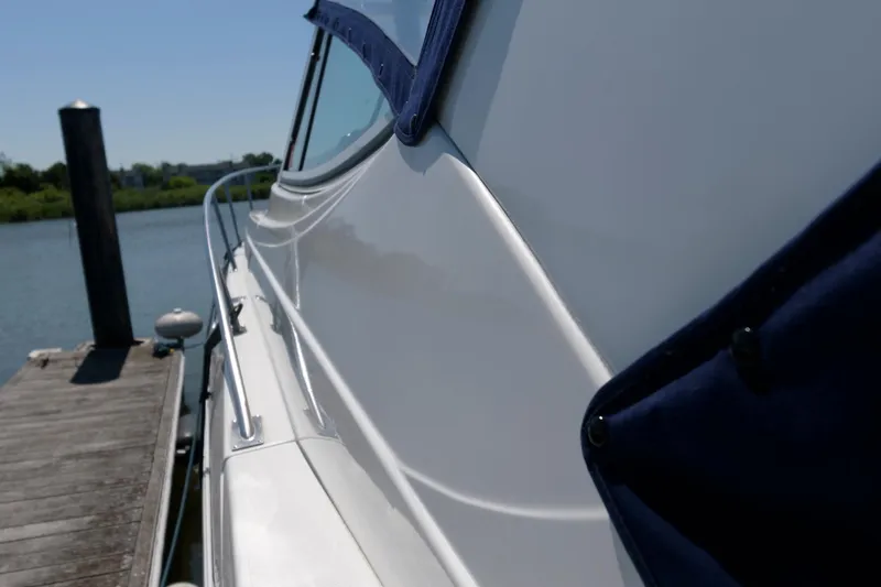 Slide: The Image of 2002 Cruisers Yachts 3275 Express docked, side view. - 8