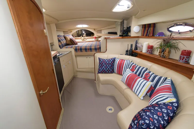 Slide: The Image of Interior of 2002 Cruisers Yachts 3275 Express with cozy seating and nautical decor. - 9