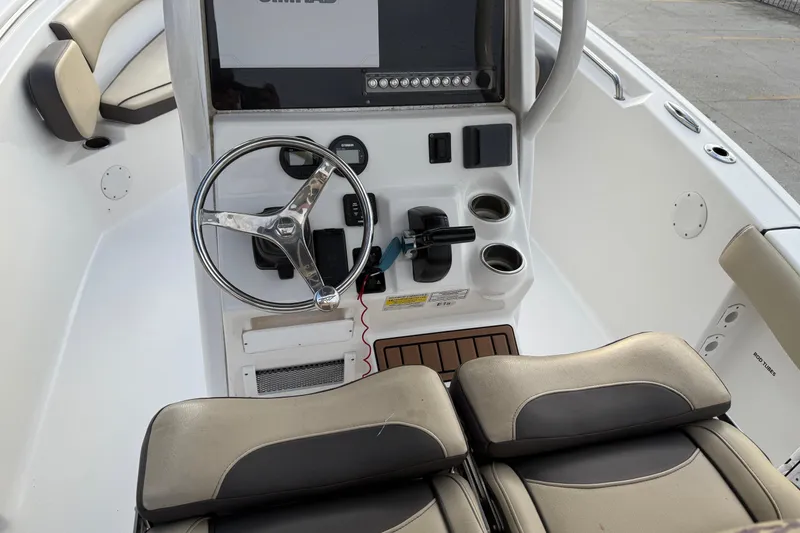 Slide: The Image of 2021 Tidewater 232 CC Adventure boat console with steering wheel and controls. - 10