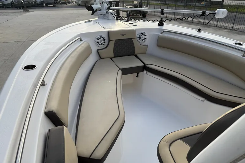 Slide: The Image of 2021 Tidewater 232 CC Adventure boat interior with cushioned seating and modern design. - 11