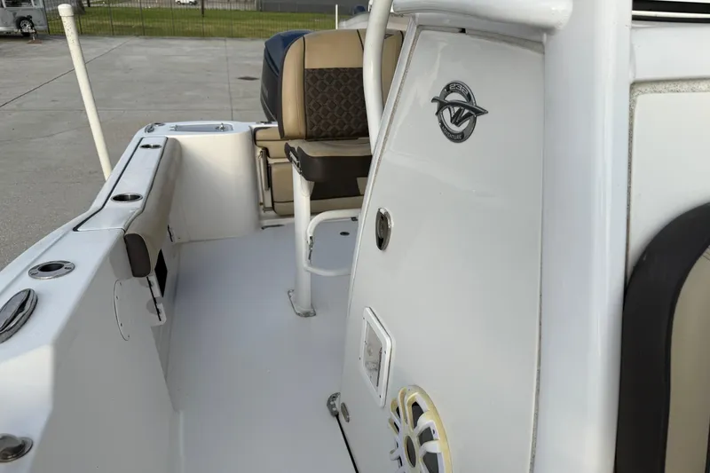 Slide: The Image of 2021 Tidewater 232 CC Adventure boat interior with seating and console details. - 14