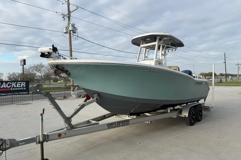 Slide: The Image of 2021 Tidewater 232 CC Adventure boat on trailer, parked outdoors. - 6