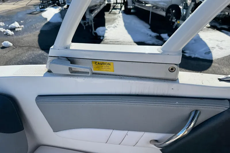 Slide: The Image of 2019 Chaparral 21 H2O Sport OB boat interior with caution label and snow background. - 10