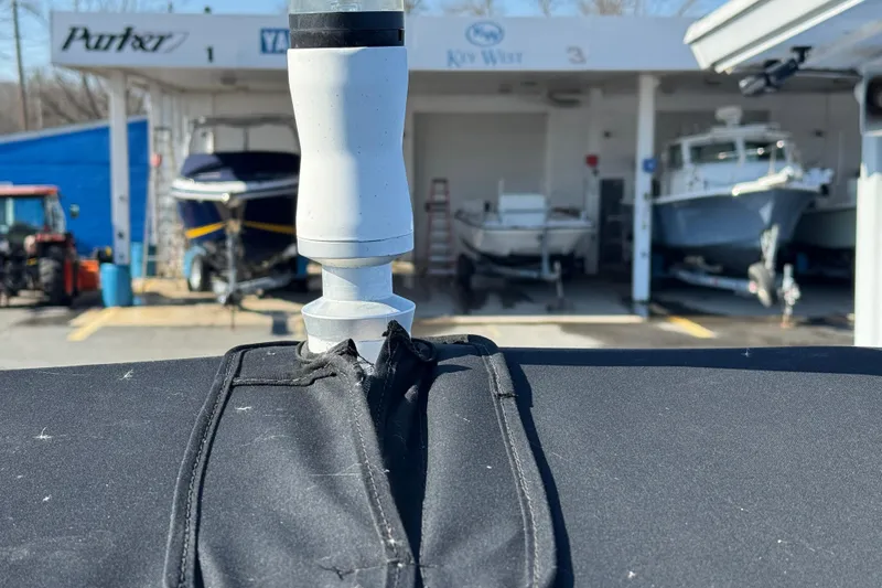 Slide: The Image of 2019 Chaparral 21 H2O Sport OB boat cover with marina background. - 11