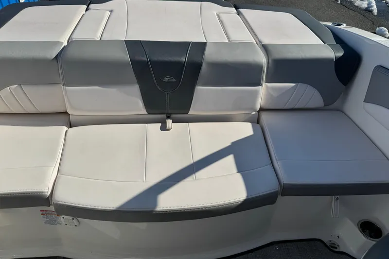 Slide: The Image of 2019 Chaparral 21 H2O Sport OB boat seating, featuring gray and white upholstery. - 14