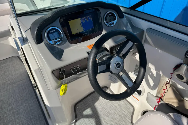 Slide: The Image of 2019 Chaparral 21 H2O Sport OB boat dashboard with steering wheel and digital displays. - 22