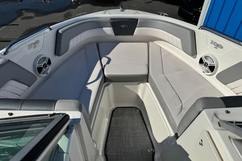 Slide: The Image of 2019 Chaparral 21 H2O Sport OB boat interior with cushioned seating and speakers. - 24