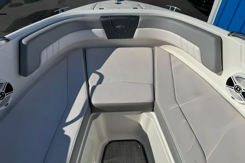 Slide: The Image of 2019 Chaparral 21 H2O Sport OB boat interior with cushioned seating and speakers. - 25