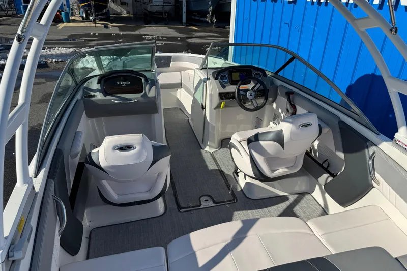 Slide: The Image of 2019 Chaparral 21 H2O Sport OB boat interior with modern seating and steering console. - 3