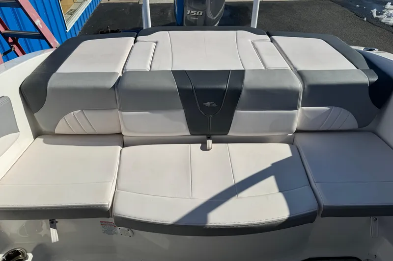 Slide: The Image of 2019 Chaparral 21 H2O Sport OB boat with cushioned seating in white and gray. - 30