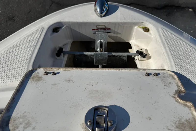 Slide: The Image of 2019 Chaparral 21 H2O Sport OB anchor compartment, showing latch and storage area. - 32