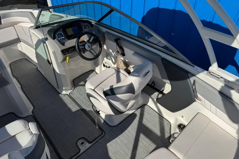 Slide: The Image of 2019 Chaparral 21 H2O Sport OB boat interior with steering wheel and seating. - 4