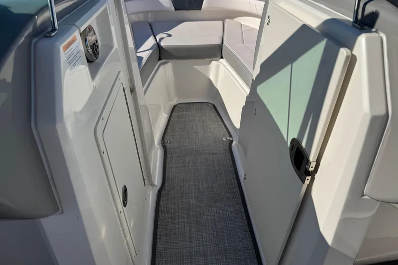 Slide: The Image of 2019 Chaparral 21 H2O Sport OB interior with seating and storage compartments. - 6