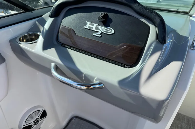 Slide: The Image of 2019 Chaparral 21 H2O Sport OB dashboard with cup holder and speaker. - 8