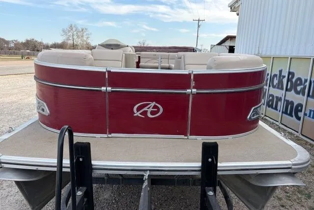 Slide: The Image of 2014 Avalon Catalina Cruise 22' pontoon boat with red exterior, parked on a trailer. - 2