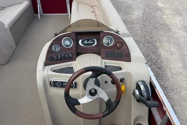 Slide: The Image of 2014 Avalon Catalina Cruise 22' boat dashboard with steering wheel and controls. - 7