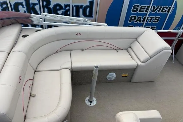 Slide: The Image of 2014 Avalon Catalina Cruise 22' boat interior with beige seating and a central pole. - 8