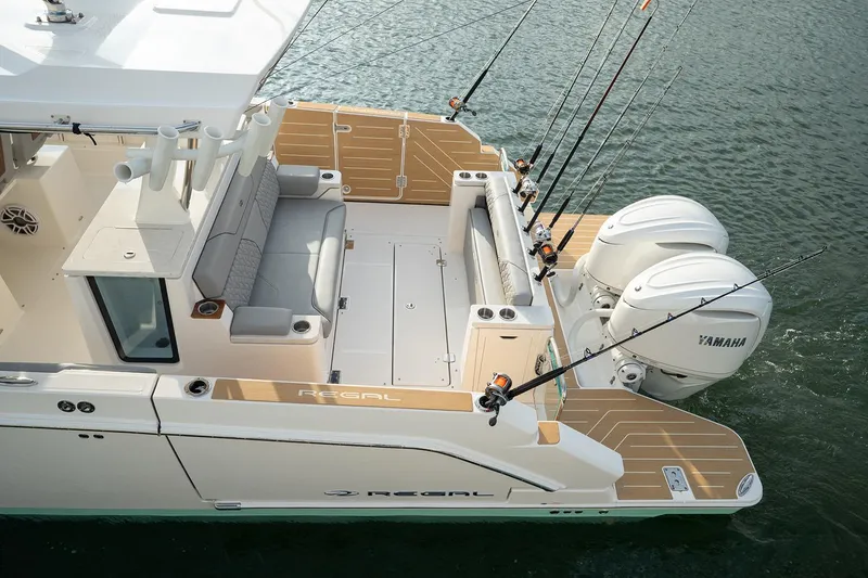Slide: The Image of Manufacturer Provided Image: 2026 Regal 34 SAV boat with Yamaha engines, fishing rods, and spacious deck on water. - 14