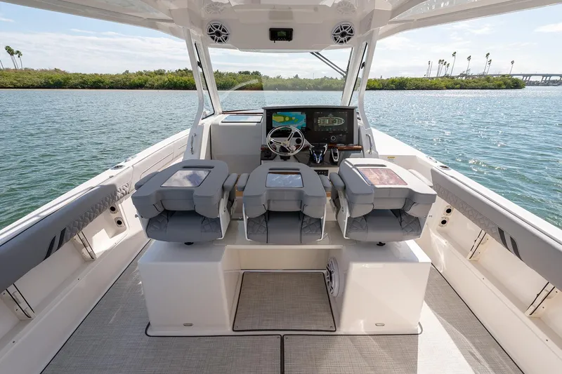 Slide: The Image of Manufacturer Provided Image: 2026 Regal 34 SAV boat interior with modern helm and seating, cruising on a sunny day. - 7