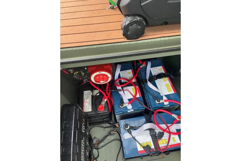 Slide: The Image of 2024 Other 1870 Bowfish boat battery compartment with multiple batteries and wiring. - 10