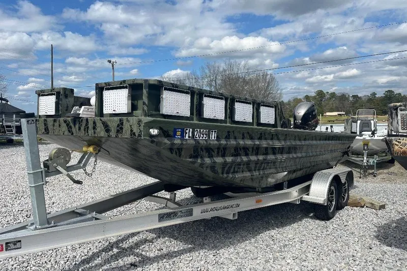 Slide: The Image of 2024 Other 1870 Bowfish boat on trailer, camo design, parked on gravel lot. - 3