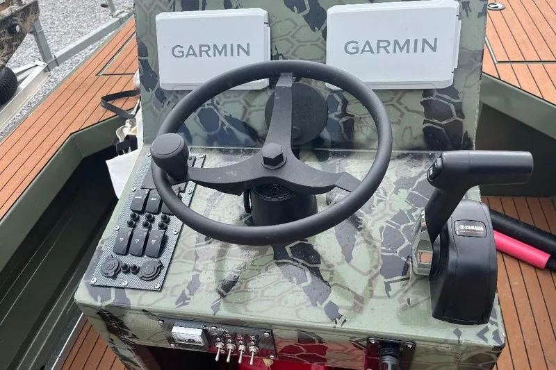 Slide: The Image of 2024 Other 1870 Bowfish boat dashboard with Garmin displays and Yamaha controls. - 8