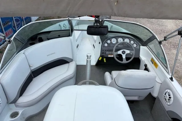 Slide: The Image of 2002 Moomba Outback boat interior with white seating and dashboard controls. - 7