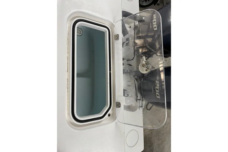 Slide: The Image of 2021 Contender 25 Tournament boat with open hatch and visible engine components. - 14
