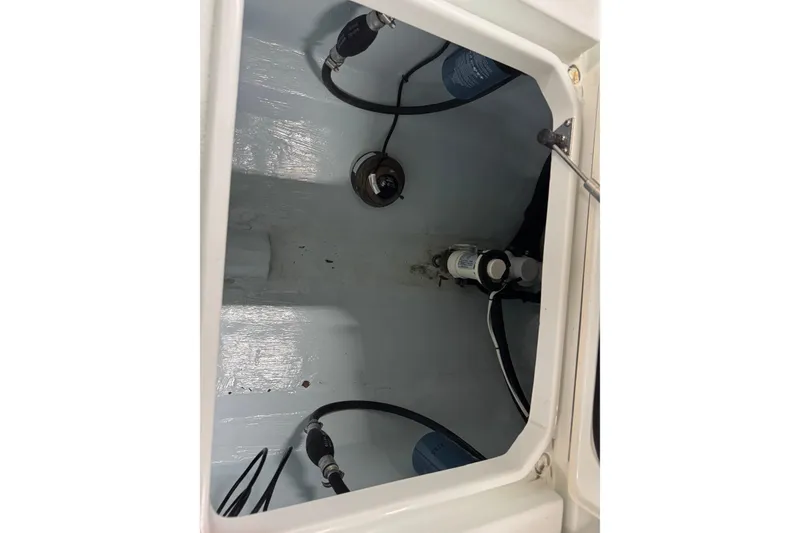 Slide: The Image of 2021 Contender 25 Tournament boat interior compartment with wiring and components. - 15