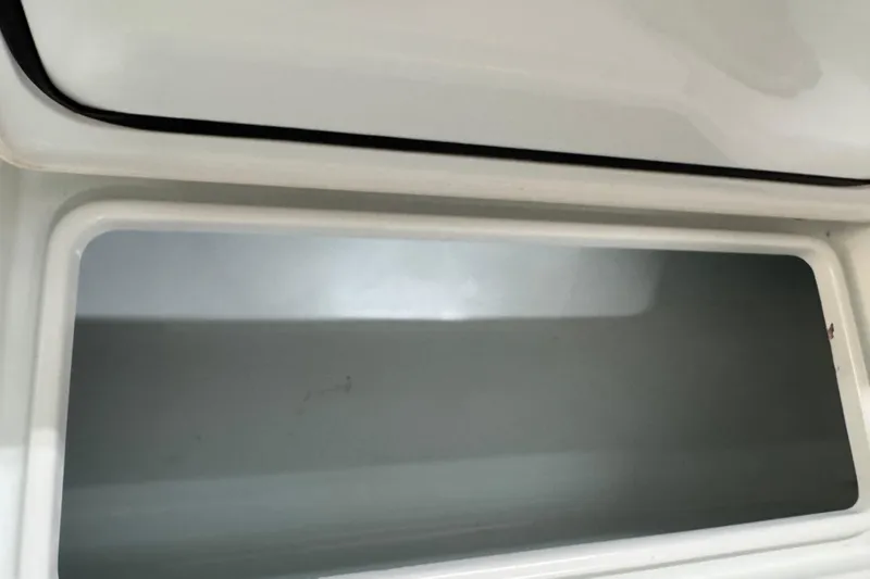 Slide: The Image of Open storage compartment on 2021 Contender 25 Tournament boat. - 16
