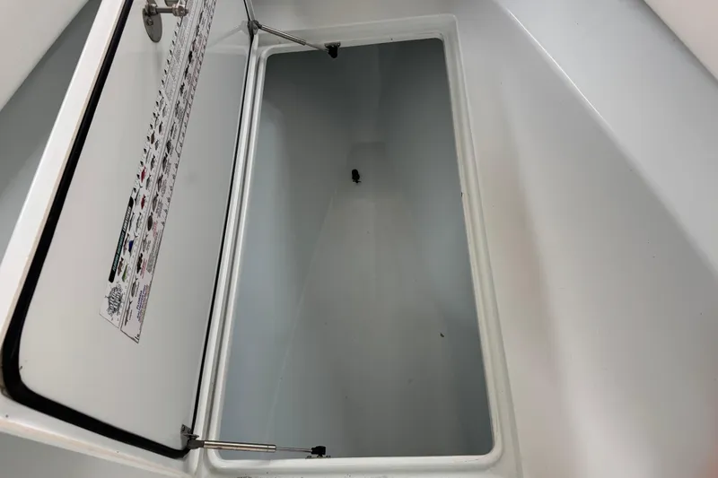 Slide: The Image of Open storage compartment on a 2021 Contender 25 Tournament boat. - 17