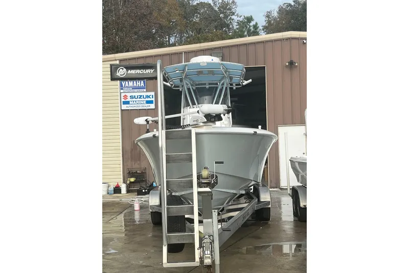 Slide: The Image of 2021 Contender 25 Tournament boat on trailer outside marine service center. - 28