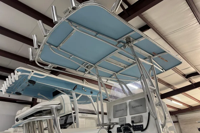 Slide: The Image of 2021 Contender 25 Tournament boat with blue T-top and Garmin electronics in a warehouse. - 3