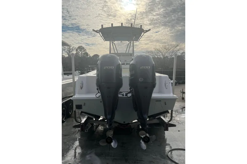 Slide: The Image of 2021 Contender 25 Tournament boat with dual Yamaha 200 engines, parked outdoors. - 33