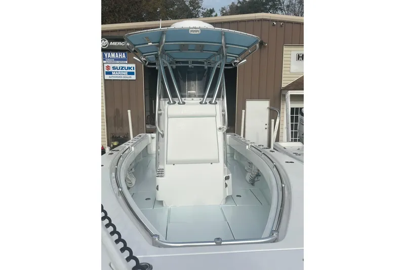 Slide: The Image of 2021 Contender 25 Tournament boat with T-top, displayed at a marine dealership. - 34