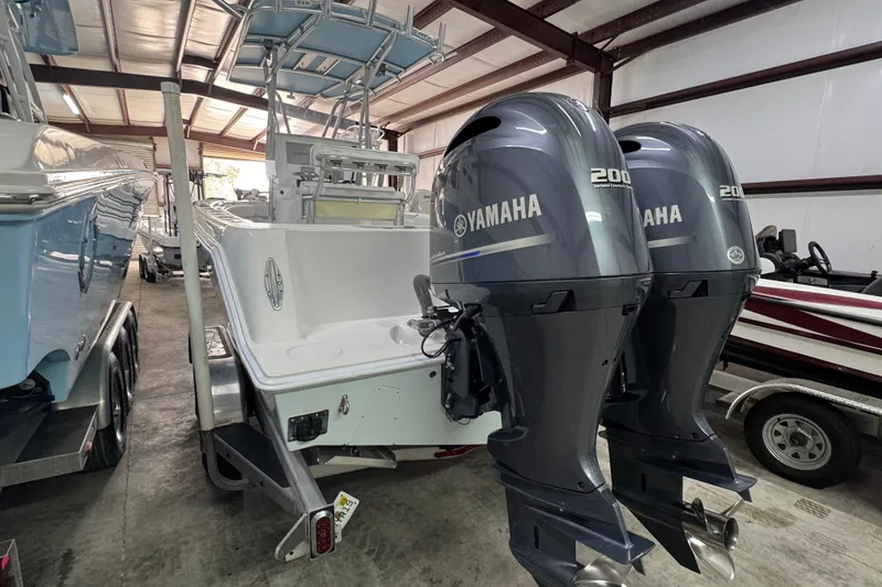 Slide: The Image of 2021 Contender 25 Tournament boat with dual Yamaha 200 engines in storage facility. - 8