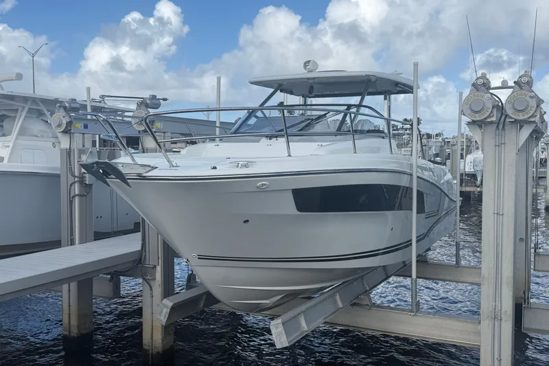 The Image of 2022 Jeanneau Leader 10.5 WA Series 2 boat docked at marina under cloudy sky. - 0