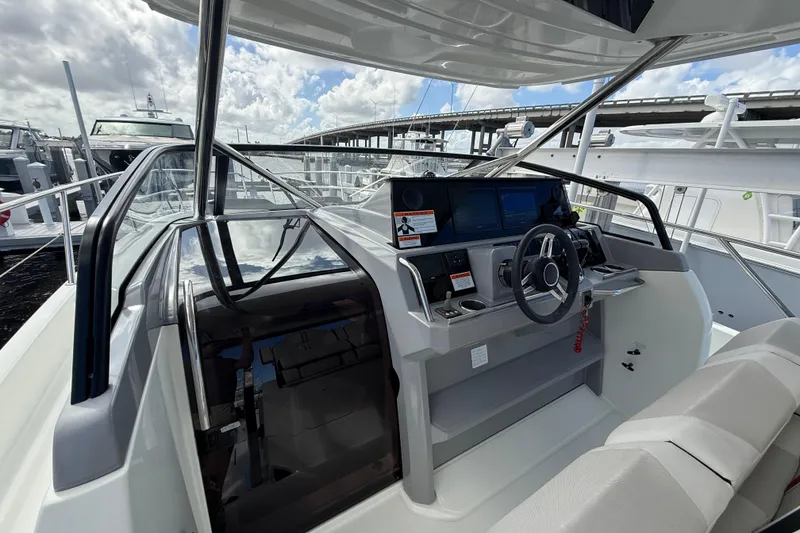 Slide: The Image of 2022 Jeanneau Leader 10.5 WA Series 2 boat cockpit with modern controls and seating. - 12