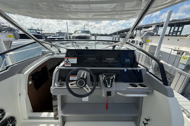 Slide: The Image of 2022 Jeanneau Leader 10.5 WA Series 2 helm with Garmin navigation, docked at marina. - 13