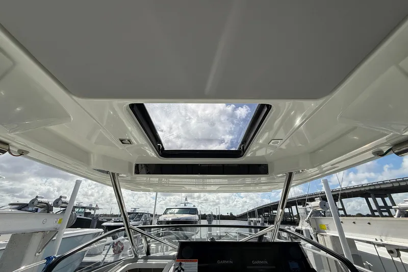 Slide: The Image of 2022 Jeanneau Leader 10.5 WA Series 2 boat interior with sunroof and navigation equipment. - 15