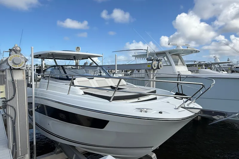 Slide: The Image of 2022 Jeanneau Leader 10.5 WA Series 2 boat docked under a clear blue sky. - 2
