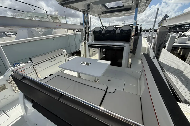 Slide: The Image of 2022 Jeanneau Leader 10.5 WA Series 2 boat interior with seating and table. - 5
