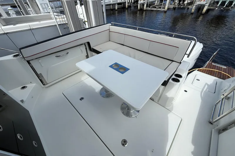 Slide: The Image of 2022 Jeanneau Leader 10.5 WA Series 2 boat deck with seating and table. - 6