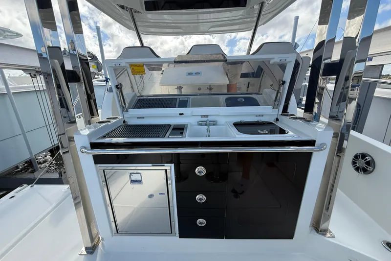 Slide: The Image of 2022 Jeanneau Leader 10.5 WA Series 2 boat kitchen with grill and sink. - 8
