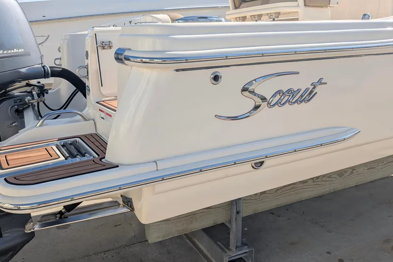 Slide: The Image of 2019 Scout 215 XSF boat with sleek design and outboard motor. - 11