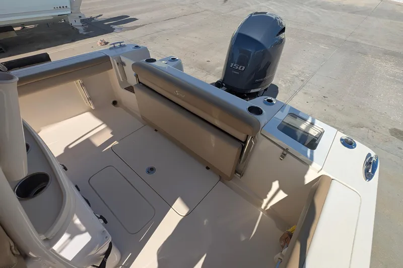 Slide: The Image of 2019 Scout 215 XSF boat interior with Yamaha 150 engine, featuring seating and storage. - 13