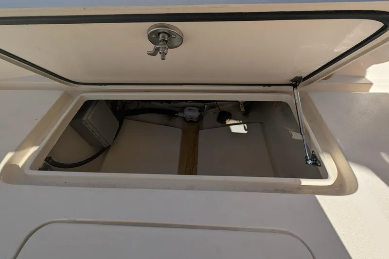 Slide: The Image of Open storage compartment on a 2019 Scout 215 XSF boat. - 15